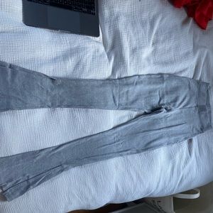 Long thick grey leggings with split at bottom.